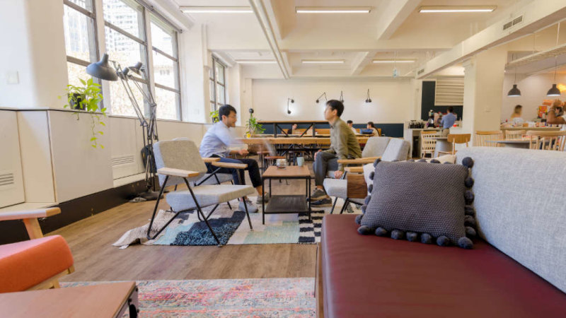 2 workers talking in an open space office design