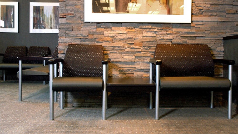 Bariatric chair with wood arm caps.