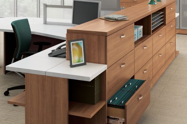 3-drawer lateral file bank of 4 units in medium cherry laminate including cubby hole storage and paper management slots.