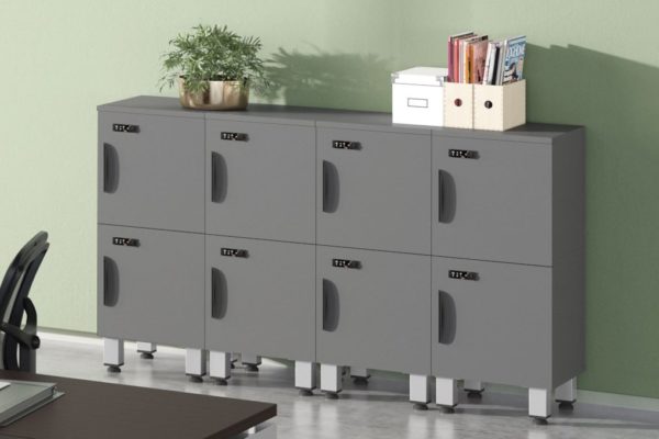 Personal metal modular storage lockers in medium grey, stacked two high with legs for easy cleaning and maintenance.