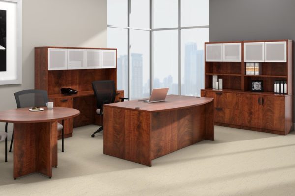 Office suite with desk, credenza, lateral file storage, conference table and hutch in medium cherry laminate.