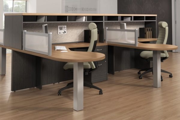 Team desking L-groups with low hutches in gray and natural cherry finishes.