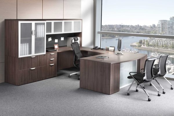 U-group in medium walnut laminate with glass accents, storage tower, and overhead hutch.