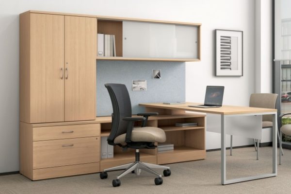 Wood veneer executive L-group in natural maple with silver accents and storage tower.