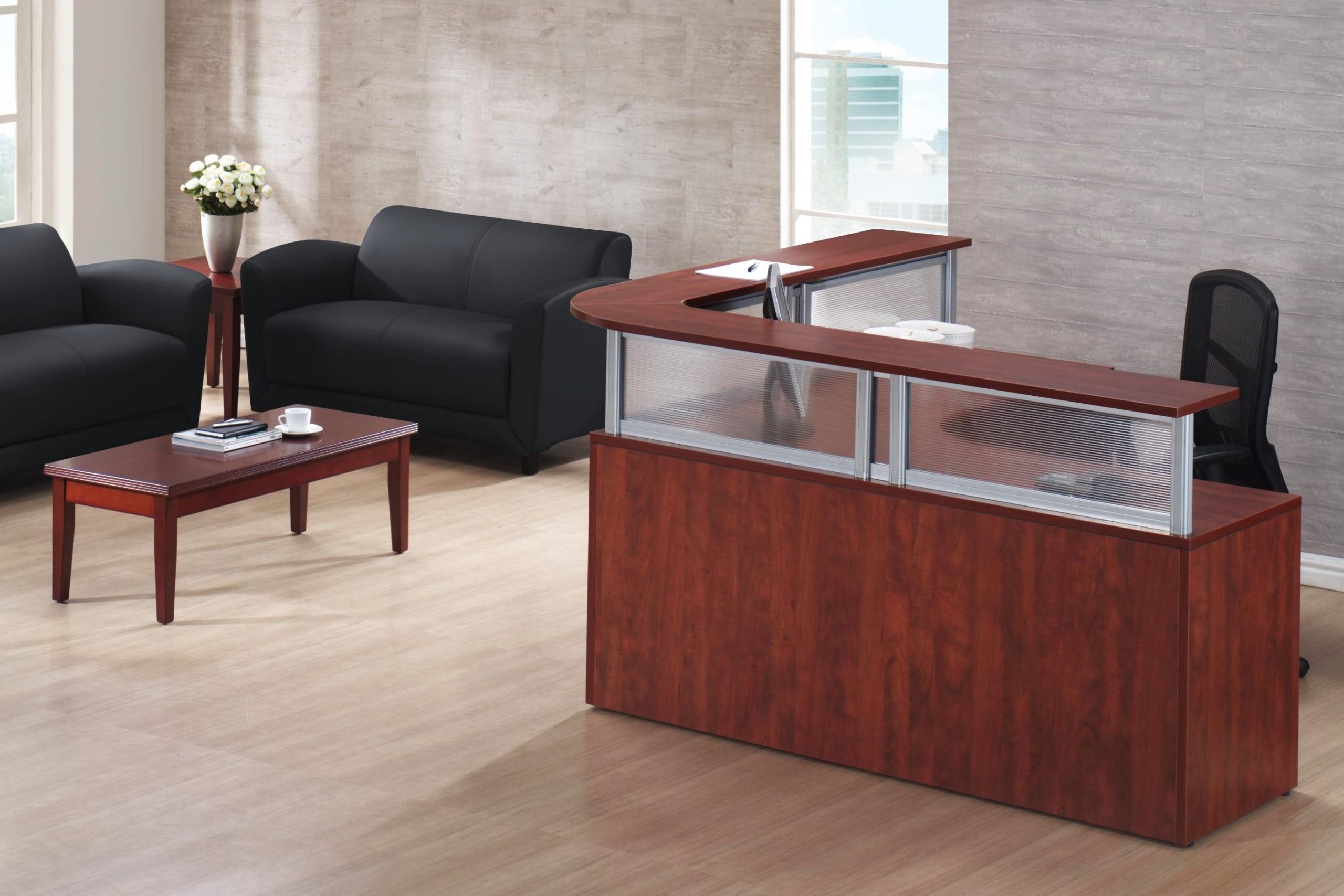 Reception L-group in medium cherry laminate with silver post transaction counter and polystyrene privacy screens.