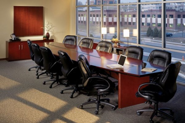 14 foot executive cherry wood veneer modular boat-shaped conference table with centered power data trough, matching slab end bases and finished in medium cherry stain.