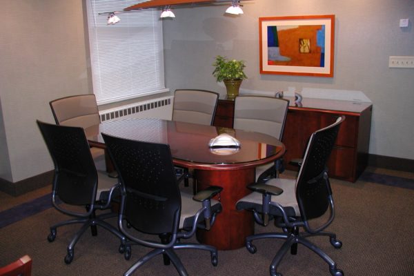 36x72 cherry veneer wood executive racetrack conference table with matching half drum bases, traditional table edge profile, and custom cut glass top for scratch and wear protection.