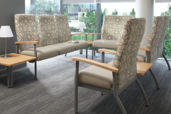 High back ganged healthcare seating group with tungsten frames and legs, designer-specified fabric, maple arm caps, and matching maple end tables.